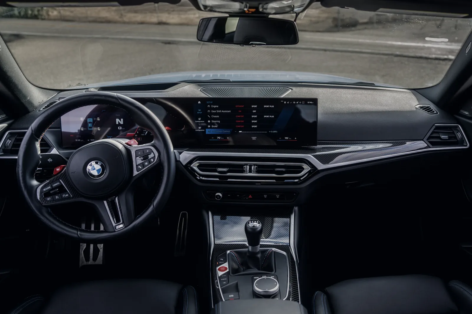 BMW M2 cockpit with the curved display and six-speed manual shifter
