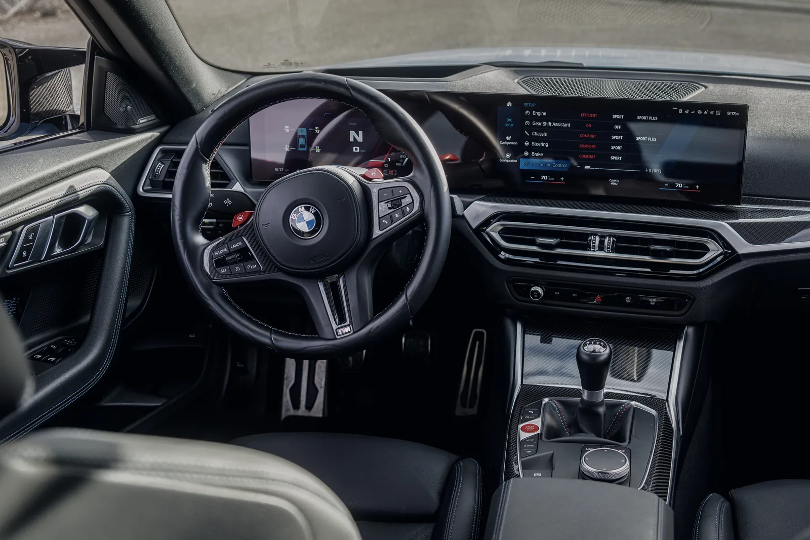BMW M2 driver's view of the steering wheel and manual gear lever