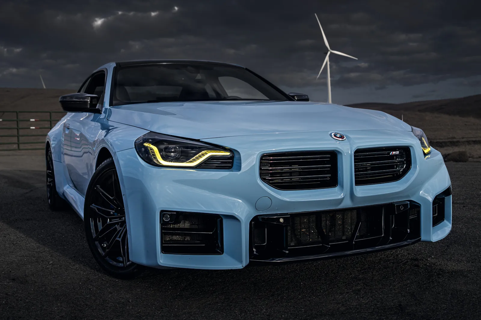 BMW M2 front three-quarter from a low angle with yellow daytime running lights