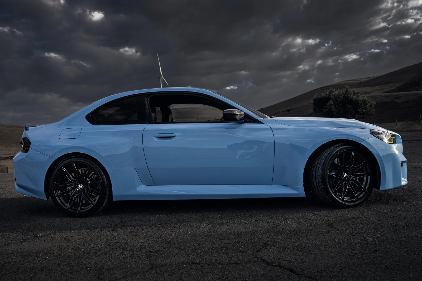 BMW M2 in side profile on a gravel lot