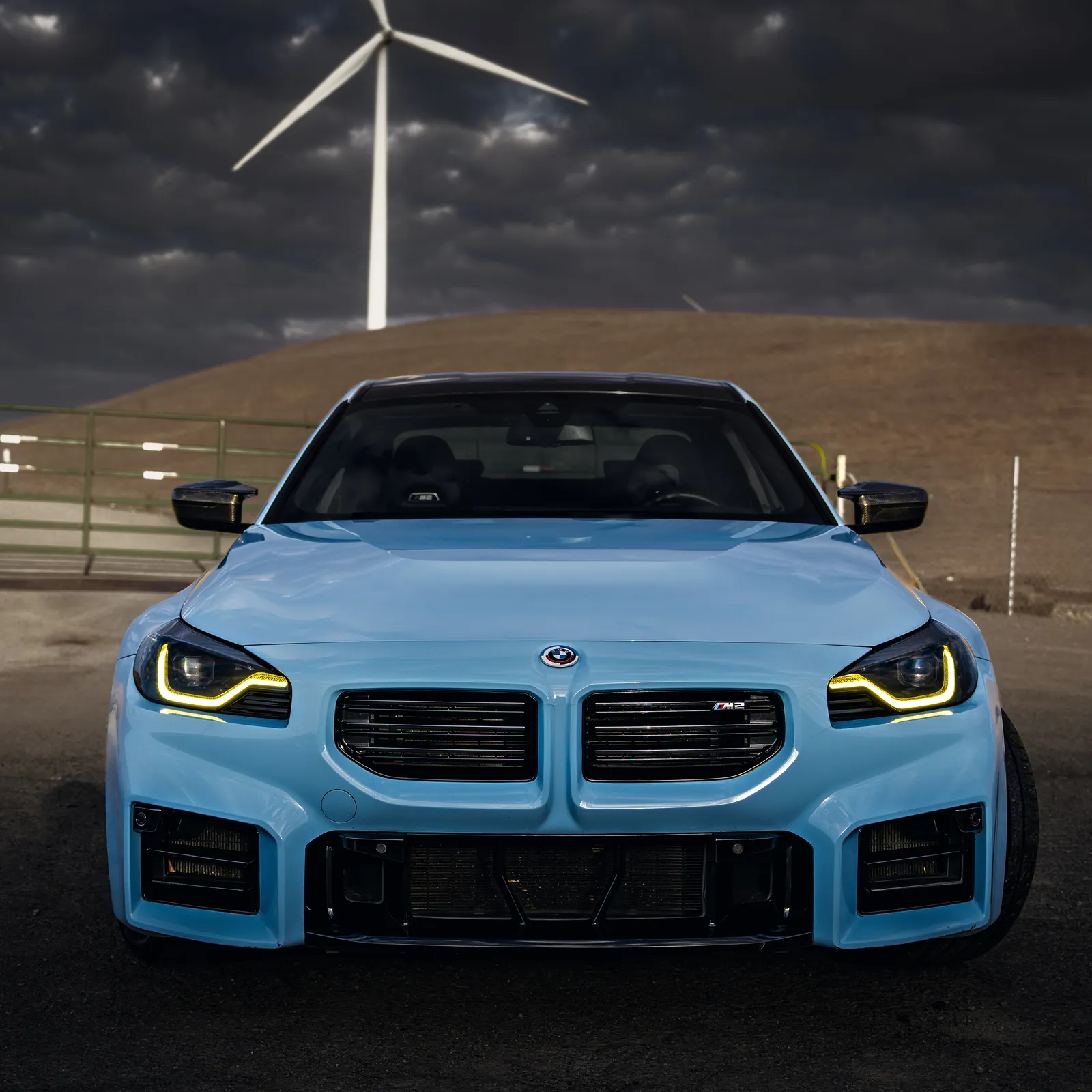 BMW M2 head-on with yellow daytime running lights